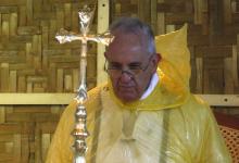 Pope Francis, in a rain poncho, attends during a Mass near Tacloban airport, January 17, 2015. PHOTO BY REUTERS/ Stefano Rellandini