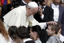Pope Francis blesses a boy during his Wednesday general audience in Saint Peter's Square at the Vatican, September 9, 2015. PHOTO BY REUTERS/Max Rossi