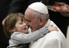Pope Francis holds a child as he leads the weekly audience in Paul VI's hall at the Vatican, January 20, 2016. PHOTO BY REUTERS/Max Rossi