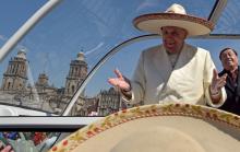Pope Francis gestures while wearing a Mariachi hat given to him by someone in the crowd on Zocalo Square in Mexico City. PHOTO BY REUTERS/Mexico Presidency