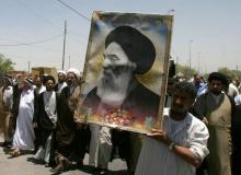 Iraqis carry a poster of top Shi'ite cleric Grand Ayatollah Ali al-Sistani during a demonstration in Najaf, 160 km (100 miles) south of Baghdad, June 13, 2007. PHOTO BY REUTERS/Ali Abu Shish
