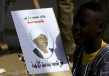 A boy holds the picture of Sudanese President Omar Hassan al-Bashir during a war torn Darfur peace campaign rally at Nyala in South Darfur, April 4, 2016. PHOTO BY REUTERS/Mohamed Nureldin Abdallah