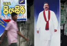 A man walks past a poster of Sri Lanka's former president Mahinda Rajapaksa ahead of a general election, in Galle, August 14, 2015. PHOTO BY REUTERS/Dinuka Liyanawatte