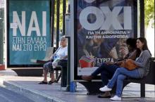 Referendum campaign posters that reads "No" (R) and "Yes" (L) in Greek are seen on a bus stop in Athens, Greece, July 4, 2015. PHOTO BY REUTERS/Jean-Paul Pelissier