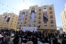 Posters depicting Palestinian President Mahmoud Abbas (R), Qatar's former Emir Sheikh Hamad bin Khalifa al-Thani (C) and Emir of Qatar Tamim bin Hamad al-Thani are seen on a building as people attend the opening ceremony of Qatari-funded construction project "Hamad City", in Khan Younis in the southern Gaza Strip, January 16, 2016. PHOTO BY REUTERS/Ibraheem Abu Mustafa