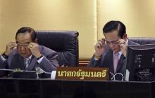 Thailand's Prime Minister Prayuth Chan-ocha (R) and Deputy Prime Minister and Defence Minister Prawit Wongsuwan don glasses before Prayuth reads out his government's policy, at the Parliament in Bangkok, September 12, 2014. PHOTO BY REUTERS/Chaiwat Subprasom