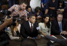 Al Jazeera television journalists Mohamed Fahmy, C, and Baher Mohamed, L, talk to the media with lawyer Amal Clooney, 2nd R, Troy Lulashnyk, R, Canadian Ambassador to Egypt, before hearing the verdict at a court in Cairo, Egypt, August 29, 2015. PHOTO BY REUTERS/Asmaa Waguih