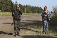 Pro-Russian activists guard a checkpoint outside the eastern Ukranian city of Luhansk