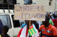 A man holds up a sign which reads, "leave power" during opposition protest to call for the immediate resignation of President Faure Gnassingbe in Lome, Togo, September 7, 2017. PHOTO BY REUTERS/Noel Kokou Tadegnon