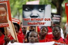 Bring Back Our Girls (BBOG) campaigners hold banners as they walk during a protest procession marking the 500th day since the abduction of girls in Chibok, along a road in Lagos, August 27, 2015. PHOTO BY REUTERS/Akintunde Akinleye