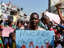 Zimbabweans hold placards during a protest against President Robert Mugabe government's handling of the economy in Harare, Zimbabwe, August 3, 2016. PHOTO BY REUTERS/Philimon Bulawayo