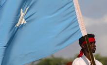 A protester carries the Somali national flag during a demonstration against Al-Shabaab militant group in Mogadishu, Somalia, October 18, 2017. PHOTO BY REUTERS/Feisal Omar