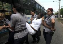 Cuban security personnel detain a member of the Ladies in White group after their weekly anti-government protest march, in Havana, September 13, 2015. PHOTO BY REUTERS/Enrique de la Osa