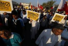 Protesters holding a signs march during a rally organised by Bahrain's main opposition party Al Wefaq in Budaiya, west of Manama