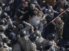 Radical protesters clash with law enforcement members on the Day of Ukrainian Cossacks during a rally near the parliament building in Kiev
