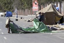 Shi'ite Houthi protesters dismantle a protest camp on a road leading to the Sanaa Airport in Sanaa