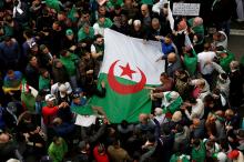 Demonstrators hold flags and banners as they return to the streets to press demands for wholesale democratic change well beyond former president Abdelaziz Bouteflika's resignation in Algiers, Algeria, April 19, 2019. PHOTO BY REUTERS/Ramzi Boudina
