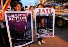 Protesters display banners seeking justice for murdered Filipino transgender Jeffrey Laude, who also goes by the name Jennifer, during a protest along a main street of Manila, October 24, 2014. PHOTO BY REUTERS/Romeo Ranoco