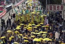 Thousands of pro-democracy protesters hold up yellow umbrellas, symbols of the Occupy Central movement, during a march in the streets to demand universal suffrage in Hong Kong, February 1,2015. PHOTO BY REUTERS/Tyrone Siu