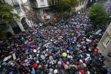 Protesters holding umbrellas to shield themselves from the rain take part in a silent march to honour late state investigator Alberto Nisman in Buenos Aires, February 18, 2015. PHOTO BY REUTERS/Enrique Marcarian