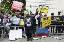 Protesters demanding the release of Rwanda's intelligence chief Karenzi Karake celebrate outside Westminster Magistrates Court after he was bailed for a bond of GB Pounds 1 Million in London, Britain, June 25, 2015. PHOTO BY REUTERS/Stefan Wermuth