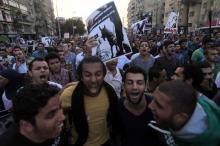Demonstrators shout slogans against the government and Egypt's former army chief Abdel Fattah al-Sisi near El-Thadiya presidential palace in Cairo