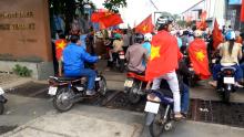 Protesters carry Vietnamese national flags as they enter a factory during an anti-China protest in Vietnam's southern Binh Duong province