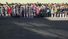 Pupils and their parents attend a festive ceremony to mark the beginning of another academic year in Makiivka, eastern Ukraine