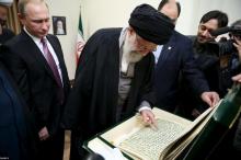 Iran's Supreme Leader Ayatollah Ali Khamenei (C) receives a gift from Russia's President Vladimir Putin (L) in Tehran, November 23, 2015. PHOTO BY REUTERS/leader.ir