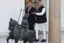 Russian President Vladimir Putin (L) and India's Prime Minister Narendra Modi arrives for a photo opportunity ahead of their meeting at Hyderabad House in New Delhi, December 11, 2014. PHOTO BY REUTERS/Adnan Abidi