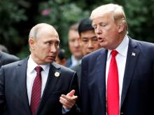 U.S. President Donald Trump and Russia's President Vladimir Putin talk during the family photo session at the APEC Summit in Danang, Vietnam, November 11, 2017. PHOTO BY REUTERS/Jorge Silva