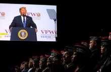 Veterans look on as U.S. President Donald Trump is seen on a screen while he addresses the Veterans of Foreign Wars’ 119th VFW national convention in Kansas City, Missouri, U.S., July 24, 2018. PHOTO BY REUTERS/Carlos Barria