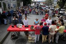 People queue to buy staple items in a Mercal, a subsidized state-run street market, in Caracas, August 4, 2015. PHOTO BY REUTERS/Carlos Garcia Rawlins