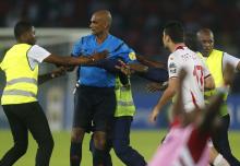 Referee Rajindraparsad Seechurn is surrounded by security as players of Tunisia confront him after losing their quarter-final soccer match of the 2015 African Cup of Nations against Equatorial Guinea in Bata, January 31, 2015. PHOTO BY REUTERS/Amr Abdallah Dalsh