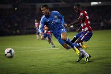 Real Madrid's Cristiano Ronaldo (L) battles for the ball with Granada's Allan Nyom