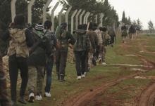 Rebel fighters carry their weapons as they move towards their positions near the front line against forces loyal to Syria's President Bashar al-Assad in Ratian village, north of Aleppo, February 17, 2015. PHOTO BY REUTERS/Ammar Abdullah