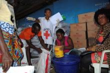 Red Cross workers distribute food at a World Food Programme storage center in Monrovia, October 16, 2014. PHOTO BY REUTERS/James Giahyue