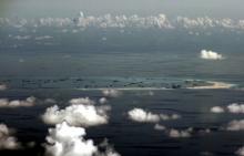An aerial photo taken though a glass window of a Philippine military plane shows the alleged on-going land reclamation by China on Mischief Reef in the Spratly Islands in the South China Sea, west of Palawan, Philippines, May 11, 2015. PHOTO BY REUTERS/Ritchie B. Tongo
