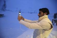 A refugee takes a selfie at the front of his camp at a hotel touted as the world's most northerly ski resort in Riksgransen, Sweden, December 15, 2015. PHOTO BY REUTERS/Ints Kalnins