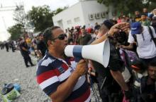 Nizar Shoukry speaks through a megaphone at railway station in Tovarnik, Croatia, September 19, 2015. Love brought Nizar Shoukry from his native Syria to Croatia and eventually a dental practice in the border town of Tovarnik. Thirty years later, war is bringing his countrymen, in a chaotic, desperate tide flowing past Shoukry's door en route to Germany and a promise of asylum. REUTERS/Antonio Bronic