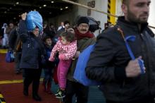 Refugees and migrants arrive aboard the passenger ferry Eleftherios Venizelos from the island of Lesbos at the port of Piraeus, near Athens, Greece, December 18, 2015. PHOTO BY REUTERS/Alkis Konstantinidis