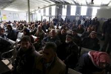 Syrian refugees wait to register at the the United Nations High Commissioner for Refugees (UNHCR) office in Amman, Jordan, December 11, 2015. PHOTO BY REUTERS/Muhammad Hamed