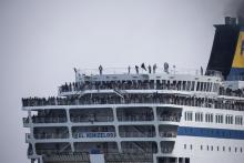 Refugees and migrants are seen on board the Eleftherios Venizelos passenger ferry as they are transferred to the Greek mainland, following their departure from the port of Mytilene on the Greek island of Lesbos, March 20, 2016. PHOTO BY REUTERS/Alkis Konstantinidis