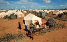 Refugees stand outside their tent at the Ifo Extension refugee camp in Dadaab, near the Kenya-Somalia border in Garissa County, Kenya, October 19, 2011. PHOTO BY REUTERS/Thomas Mukoya