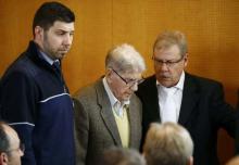 Reinhold H. (2L), a 94-year-old former guard at Auschwitz, arrives with his lawyer Andreas Scharmer (R) in the courtroom before his trial in Detmold, Germany, February 11, 2016. PHOTO BY REUTERS/Wolfgang Rattay