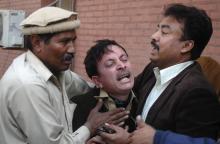 A man cries over the death of his relative, who was killed in an explosion in a Shi'ite mosque, outside a hospital in Peshawar, February 13, 2015. PHOTO BY REUTERS/Khuram Parvez
