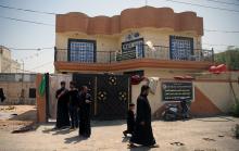 Relatives of Saad Khudair Abbas, who was killed with a group of youth by Islamic State militants at Kirkuk road, are seen outside a house in Kerbala, Iraq July 5, 2018. PHOTO BY REUTERS/Abdullah Dhiaa al-Deen
