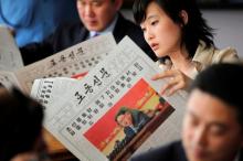 Foreign reporters and their government guides follow, in newspapers and broadcasted on television, the address by North Korean leader Kim Jong Un to the Workers' Party of Korea (WPK) congress, at a hotel in central Pyongyang, North Korea, May 8, 2016. PHOTO BY REUTERS/Damir Sagolj