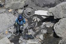 A French rescue worker inspects the debris from the Germanwings Airbus A320 at the site of the crash, near Seyne-les-Alpes, French Alps, March 29, 2015. PHOTO BY REUTERS/Gonzalo Fuentes