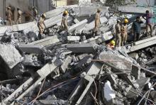 Rescue workers conduct a search operation for survivors at the site of a collapsed 11-storey building that was under construction on the outskirts of the southern Indian city of Chennai